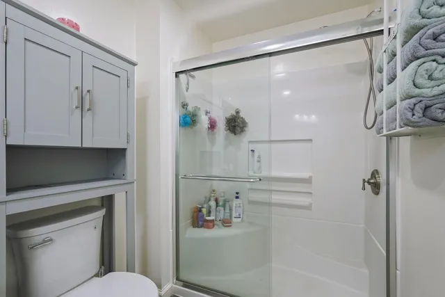 a spacious bedroom with a bed and cabinets