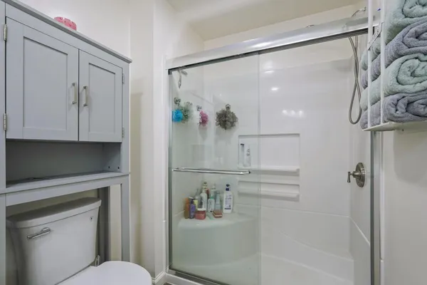 a spacious bedroom with a bed and cabinets