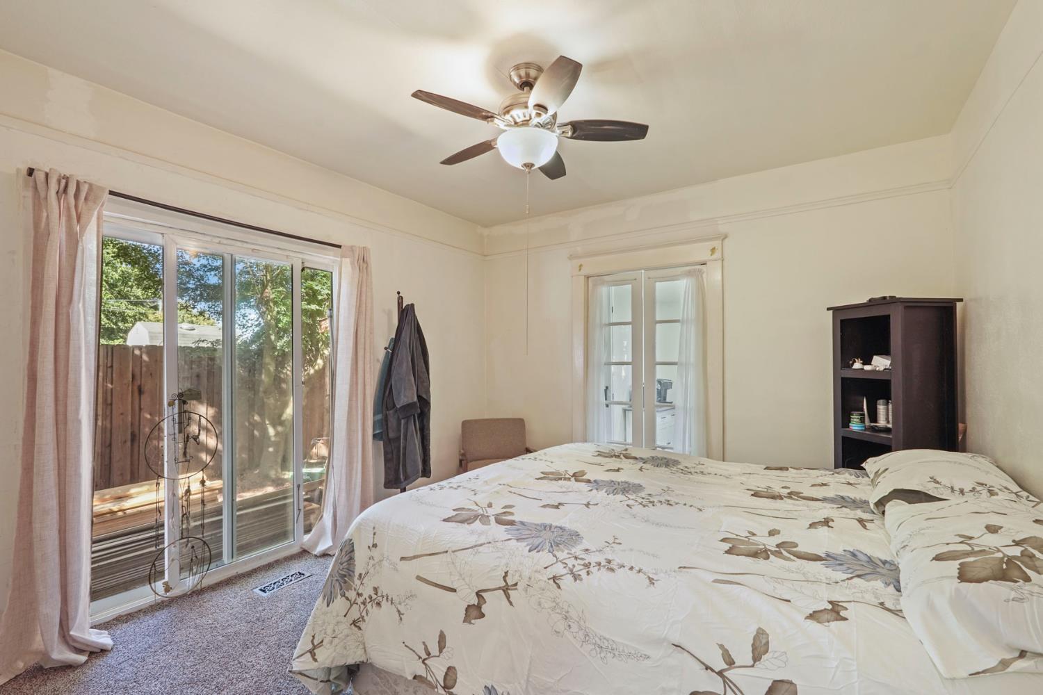 18529 Highway 88 Clements, CA 95237 - Photo 15 of 42 a bedroom with a large bed and a large window