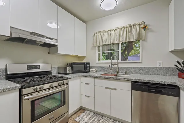 a kitchen with a table and chairs in it