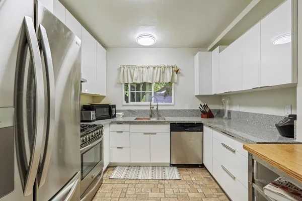 a kitchen with a refrigerator sink and stove