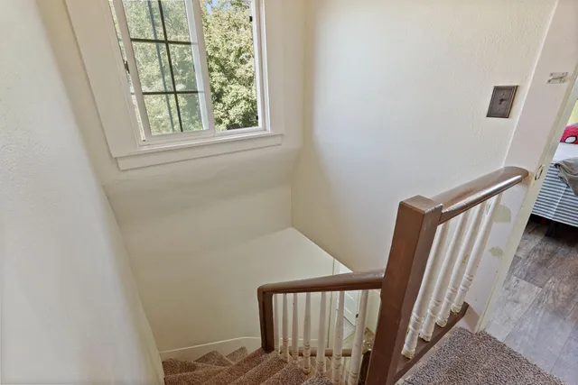 a view of a patio with table and chairs and potted plants