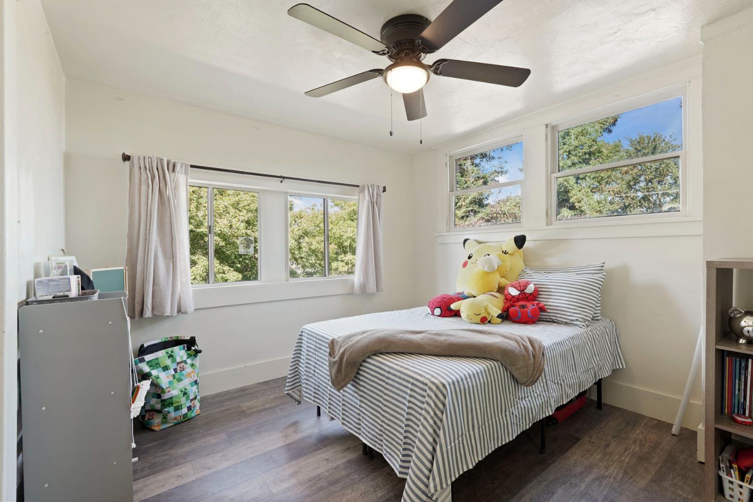 18529 Highway 88 Clements, CA 95237 - Photo 28 of 42 a bedroom with a bed and a chandelier