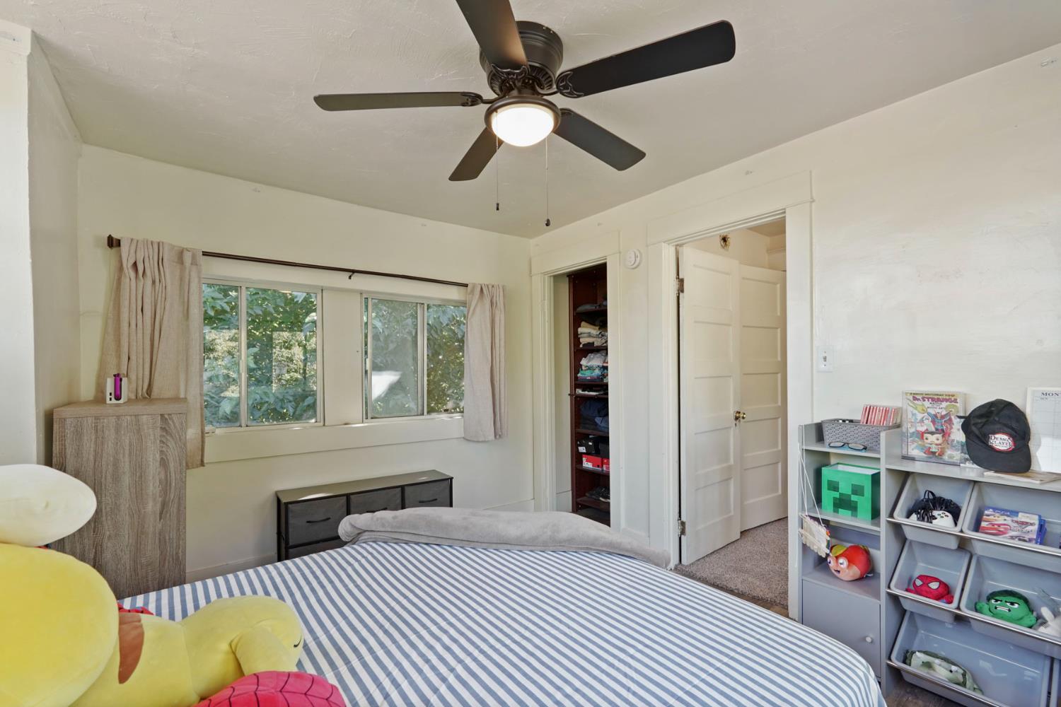 18529 Highway 88 Clements, CA 95237 - Photo 29 of 42 a bedroom with a bed and a window