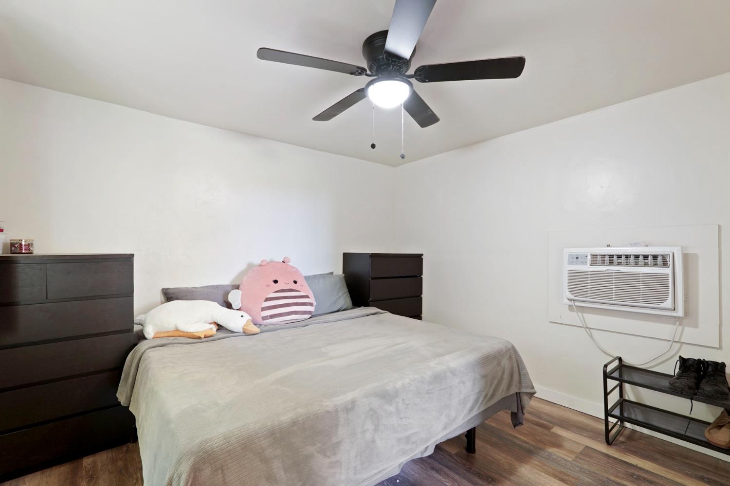 18529 Highway 88 Clements, CA 95237 - Photo 30 of 42 a bedroom with a bed and a chandelier