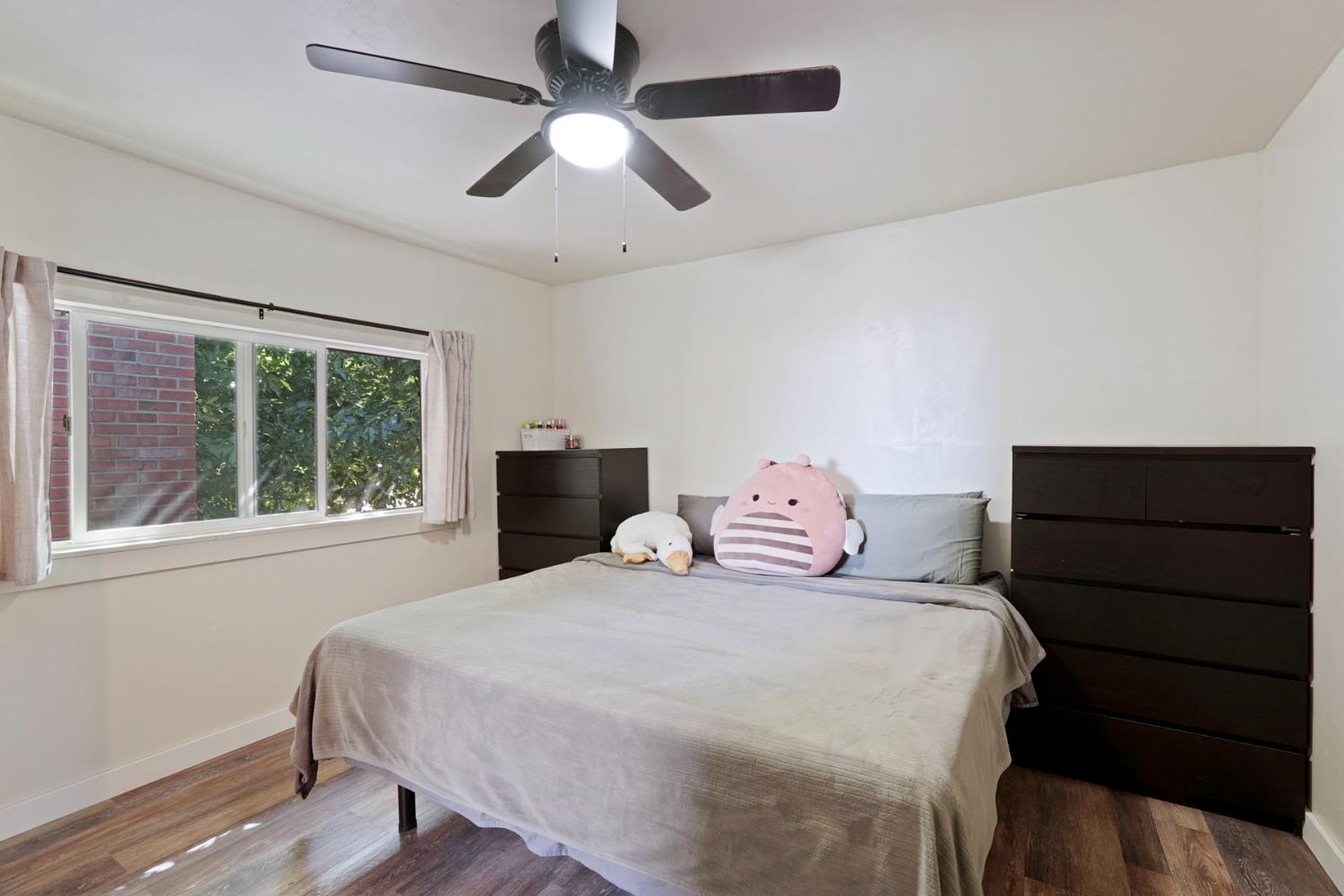 18529 Highway 88 Clements, CA 95237 - Photo 31 of 42 a bedroom with a bed and a dresser