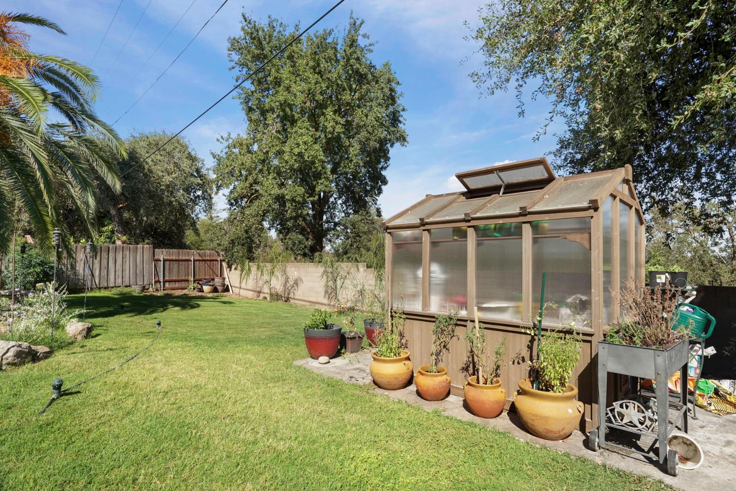 18529 Highway 88 Clements, CA 95237 - Photo 42 of 42 a backyard of a house with table and chairs potted plants and a large tree