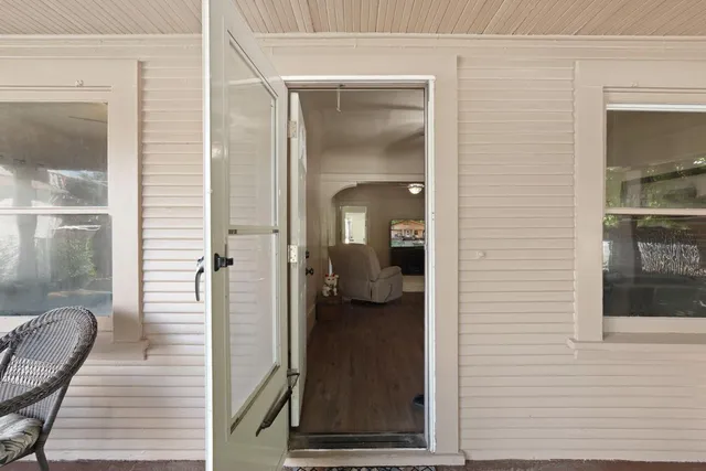 a living room with furniture ceiling fan and a window
