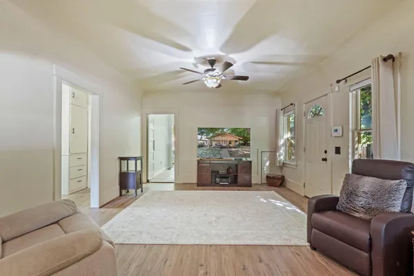 a living room with furniture and a chandelier