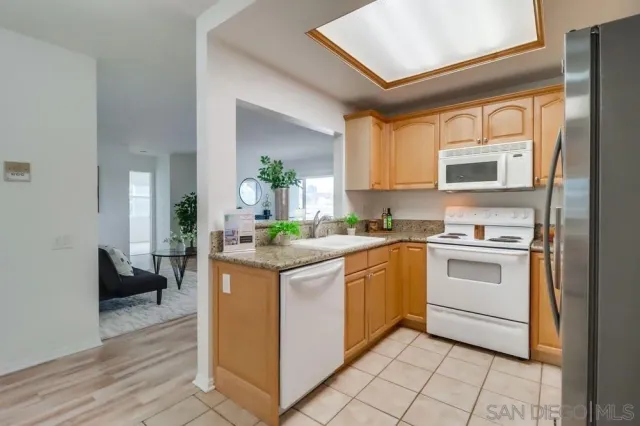 a kitchen with stainless steel appliances granite countertop a stove and a sink