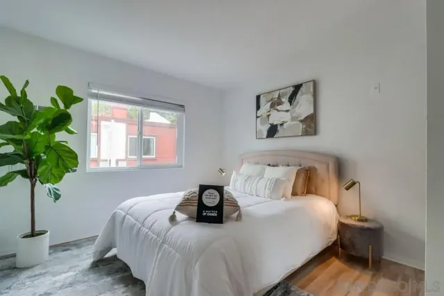 a bedroom with bed and a potted plant