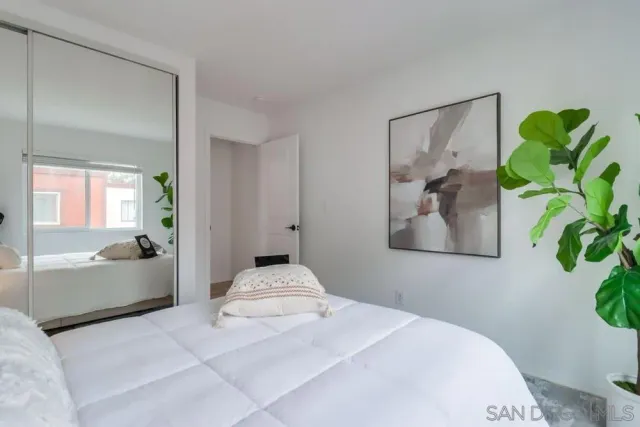 a bedroom with a bed and a couch