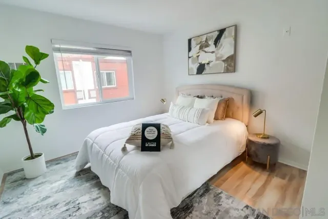 a bedroom with bed and a window