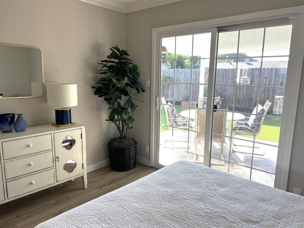 3589 Nina Street Oceanside, CA 92056 - Photo 17 of 33 a bedroom with a bed and large window with outer view