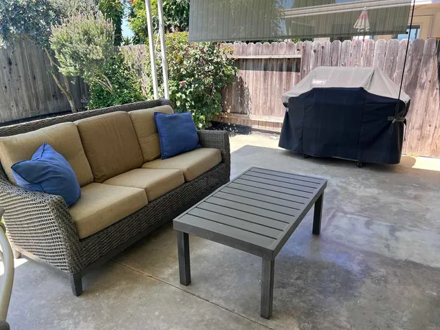 a view of a patio with couches and a fire pit