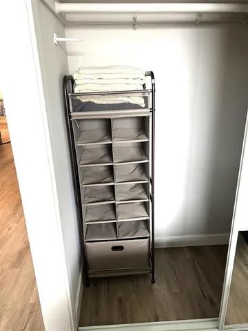 a view of walk in closet with empty racks