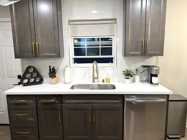 a kitchen with a sink and cabinets
