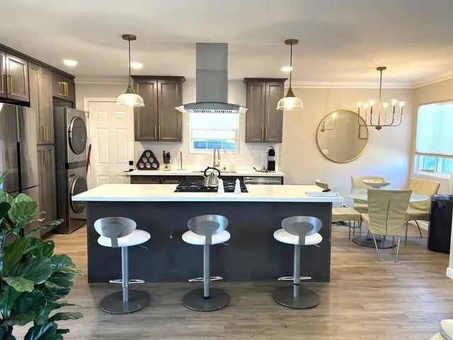 a kitchen with cabinets and chairs