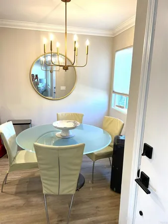 a dining room with furniture and wooden floor