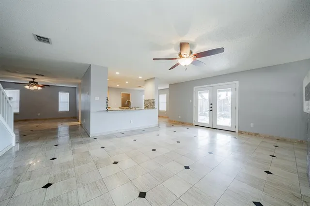 a bathroom with a granite countertop sink and a toilet