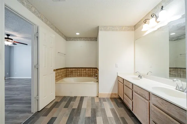 a bathroom with a tub and shower
