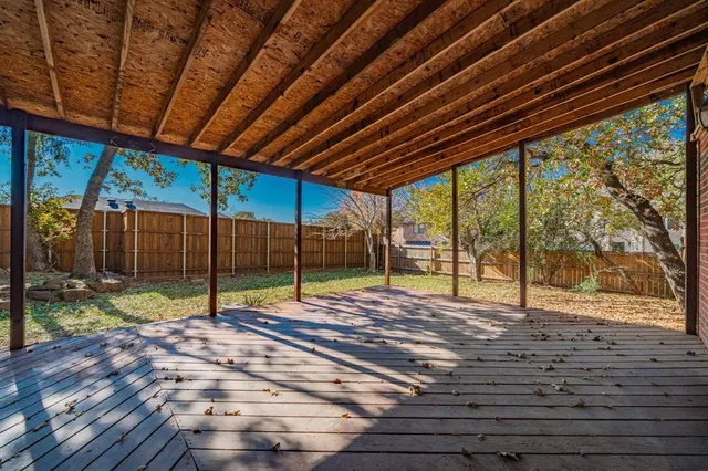 a front view of a building with large trees