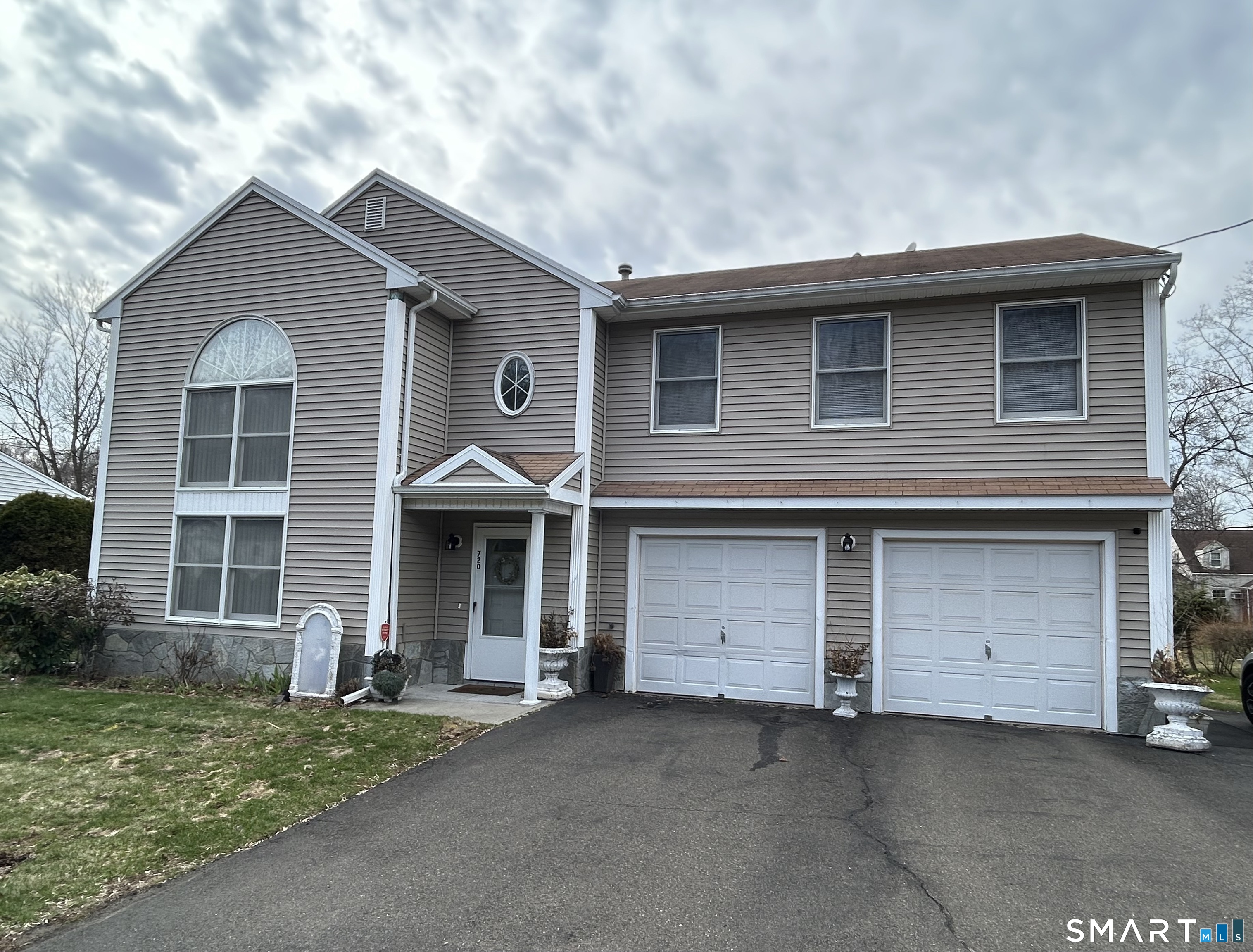 a front view of a house with a yard and garage