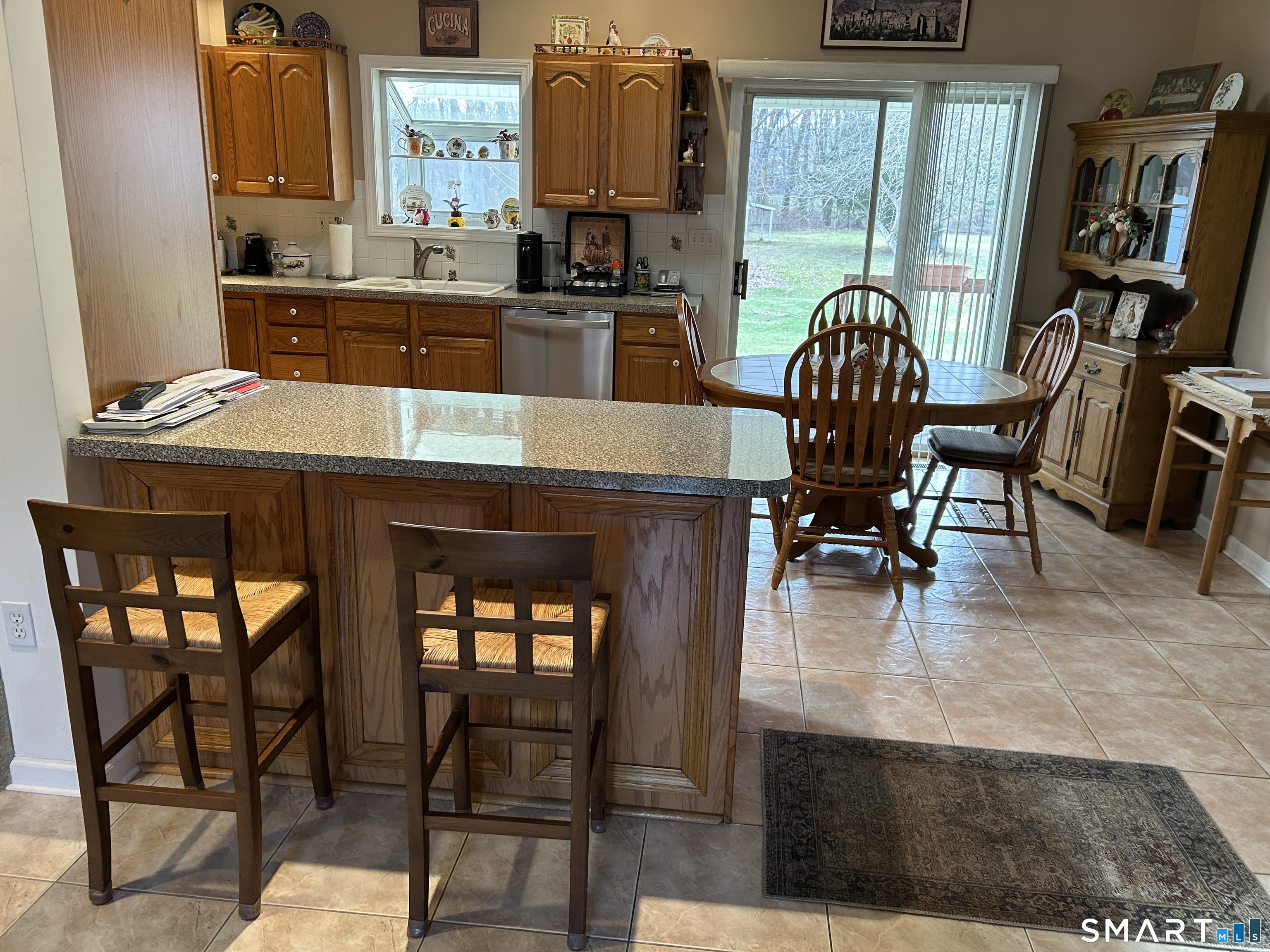720 Circular Avenue Hamden, CT 06514 - Photo 13 of 35 a kitchen with a table chairs and a refrigerator