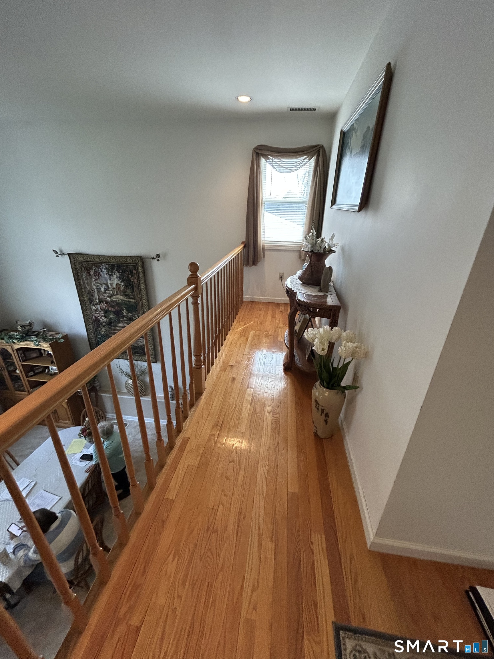 720 Circular Avenue Hamden, CT 06514 - Photo 17 of 35 a view of a hallway with wooden floor and stairs