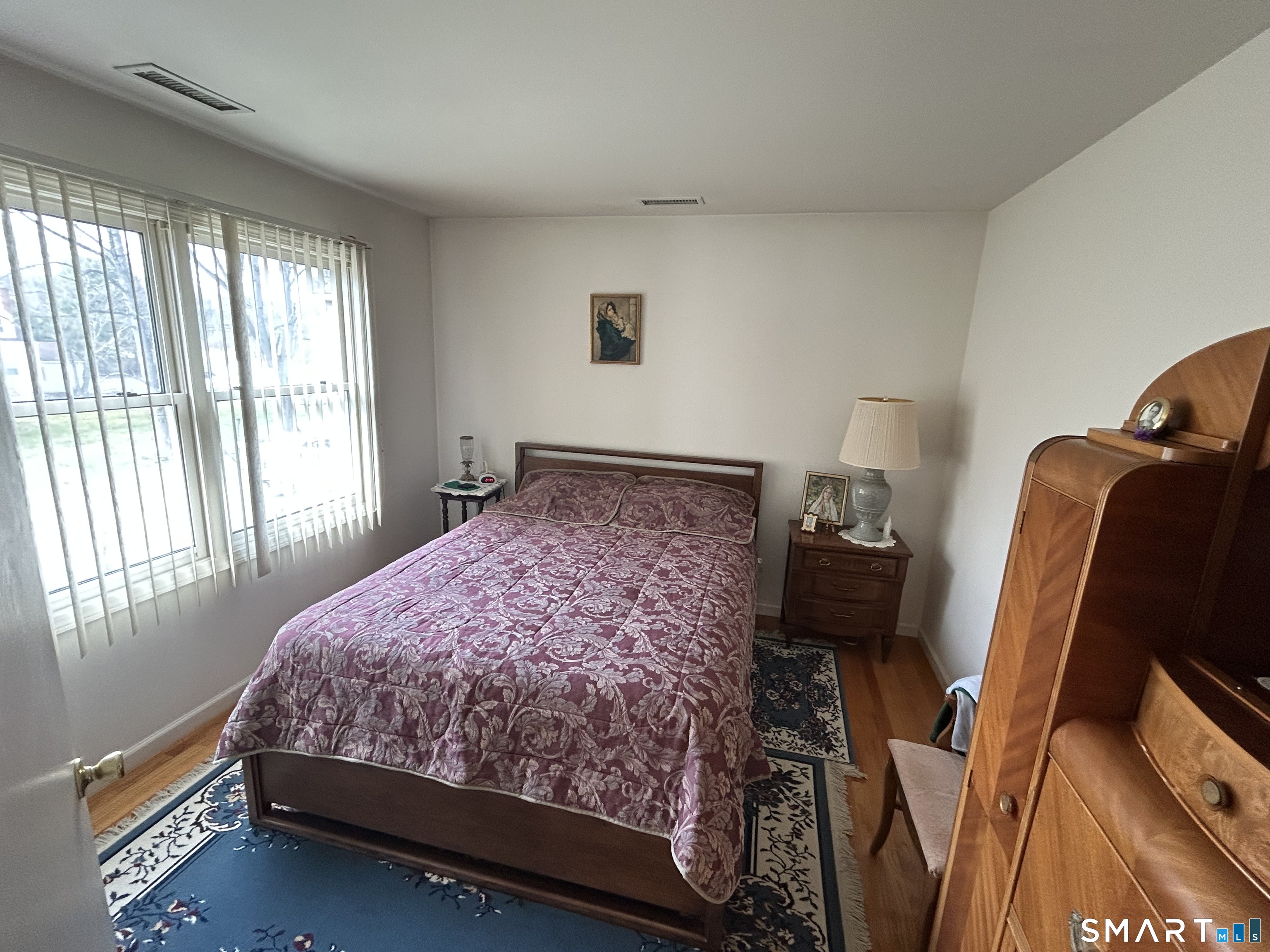 720 Circular Avenue Hamden, CT 06514 - Photo 23 of 35 a bed sitting in a bedroom next to a window