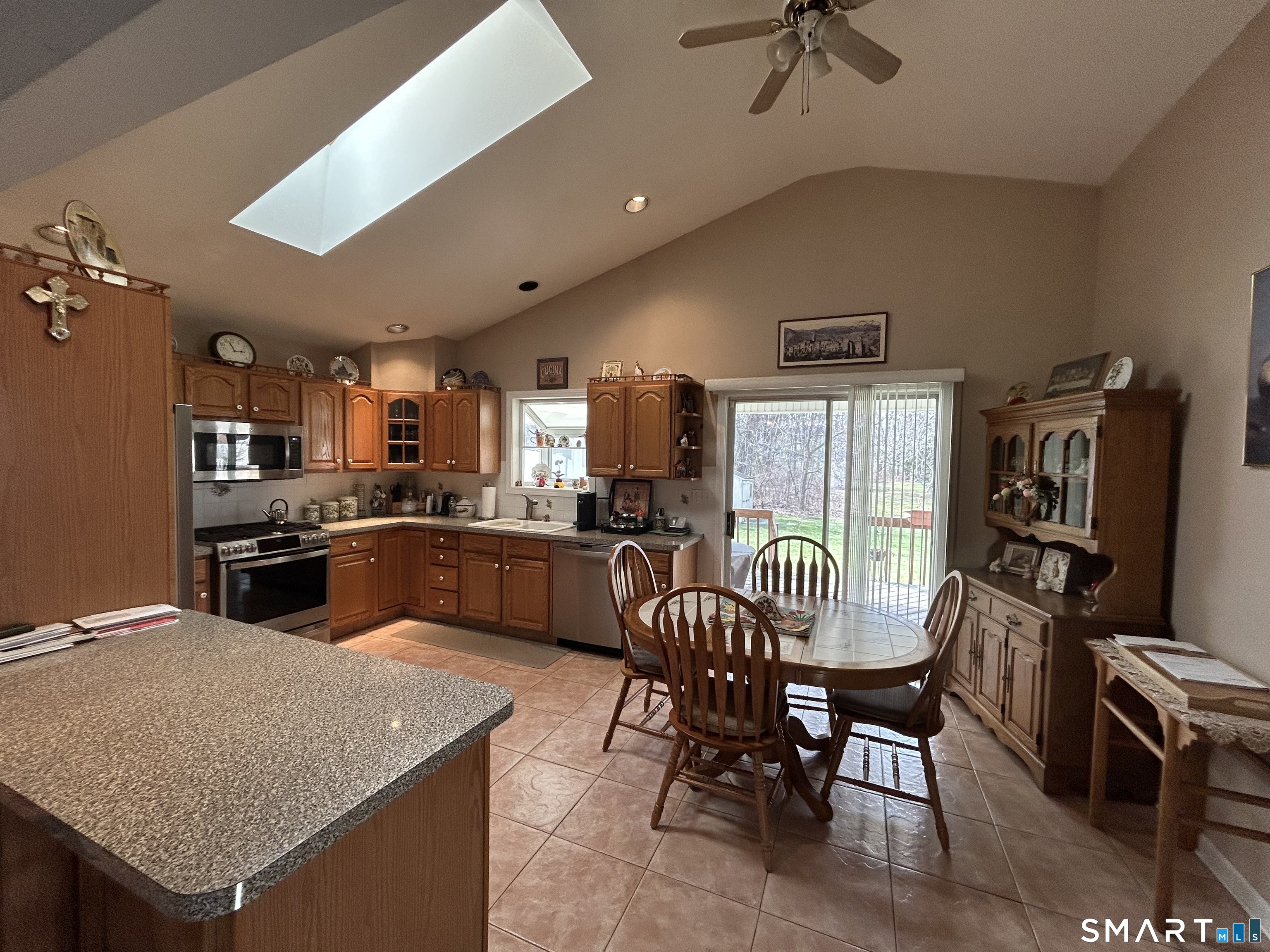 720 Circular Avenue Hamden, CT 06514 - Photo 10 of 35 a kitchen with a table chairs microwave and cabinets