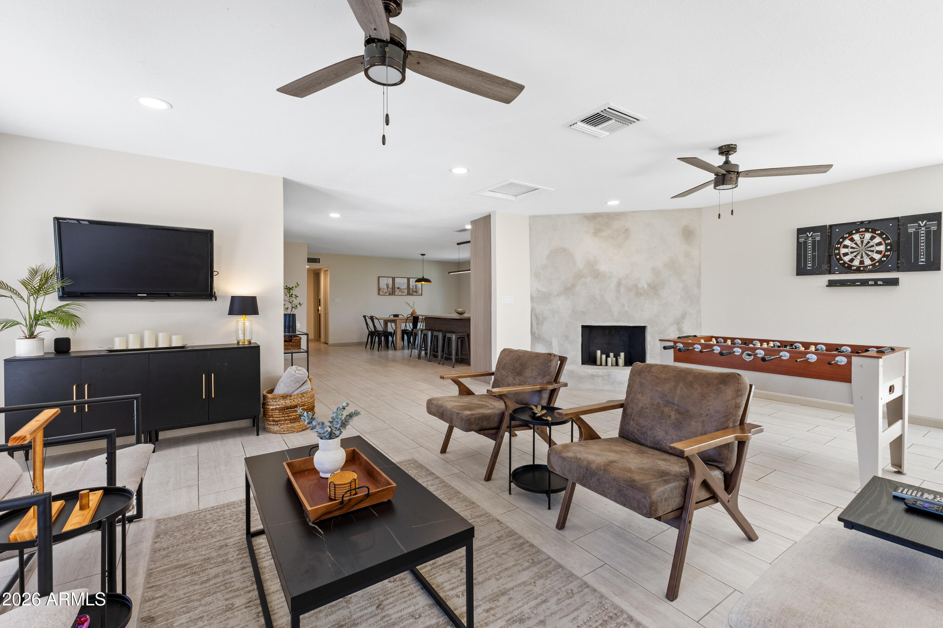 111 South Cholla Street Gilbert, AZ 85233 - Photo 16 of 34 a living room with furniture a fireplace and a flat screen tv