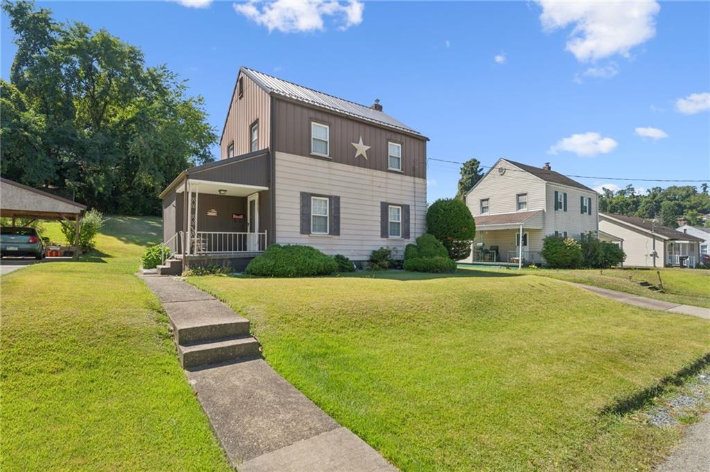 1813 Service Lane Monessen, PA 15062 - Photo 1 of 31 a front view of a house with yard and green space