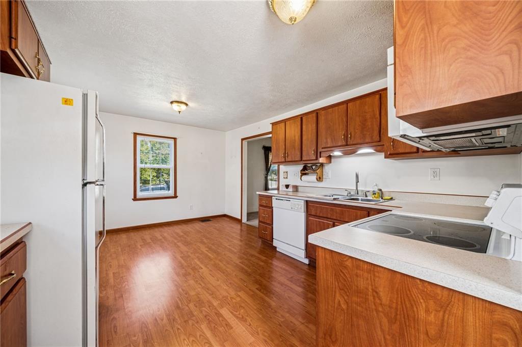 1813 Service Lane Monessen, PA 15062 - Photo 14 of 31 a kitchen with granite countertop a sink and a refrigerator