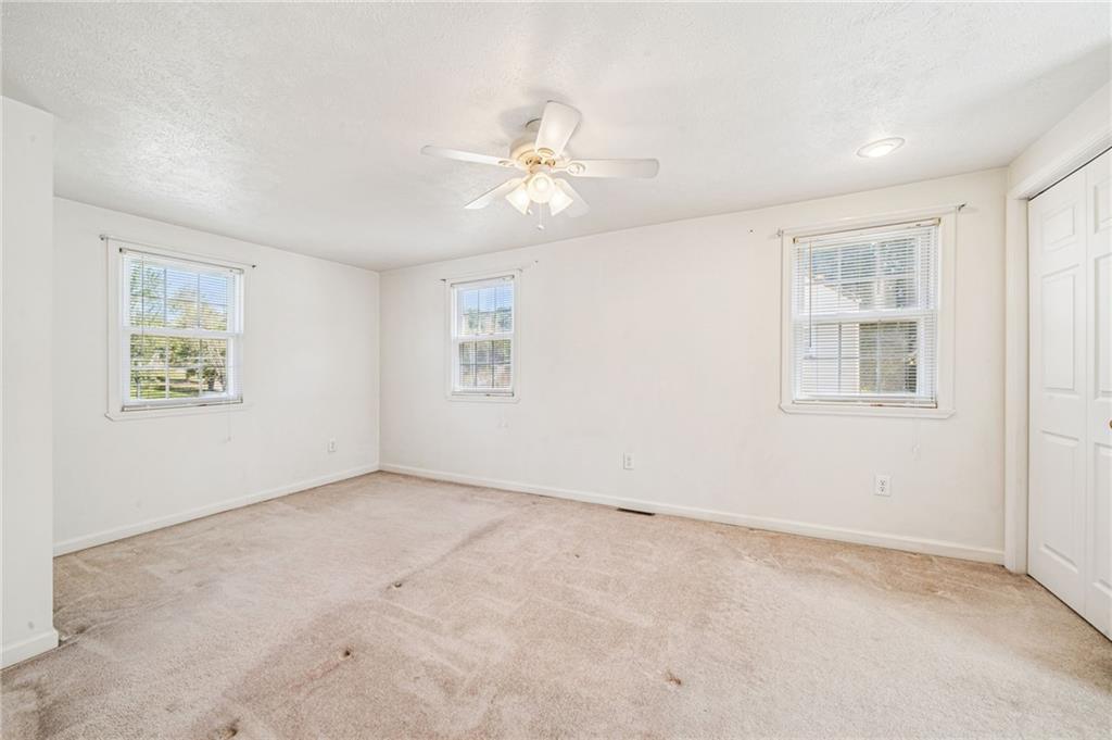 1813 Service Lane Monessen, PA 15062 - Photo 22 of 31 an empty room with windows and fan