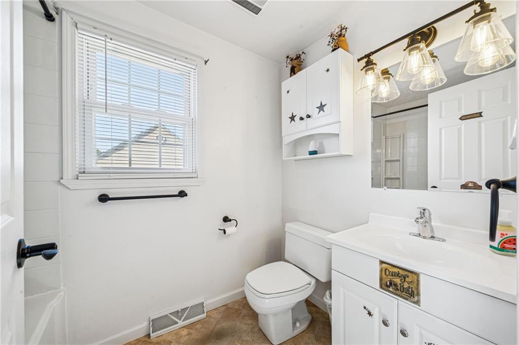 1813 Service Lane Monessen, PA 15062 - Photo 24 of 31 a bathroom with a sink a toilet and a mirror