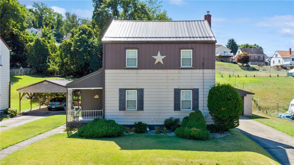 1813 Service Lane Monessen, PA 15062 - Photo 3 of 31 a front view of a house with garden