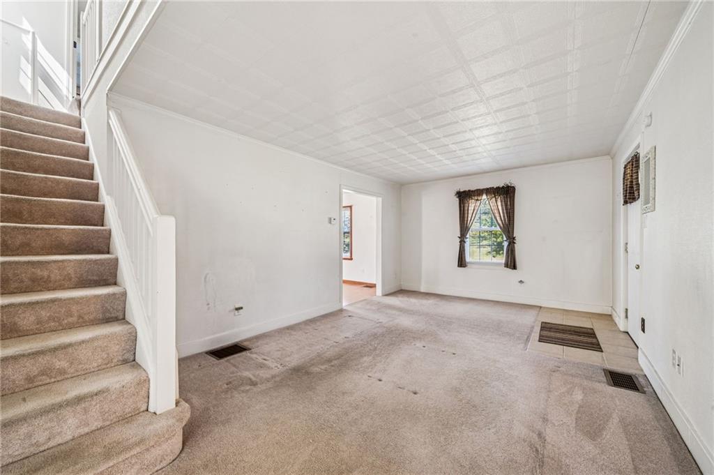 1813 Service Lane Monessen, PA 15062 - Photo 9 of 31 a view of an empty room with stairs and a window