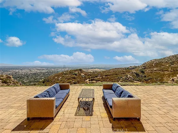 a view of a terrace with lawn chairs