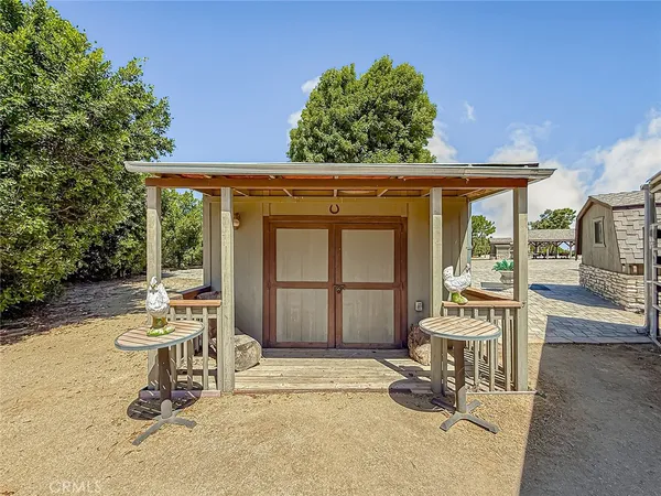 a view of a house with pool and chairs