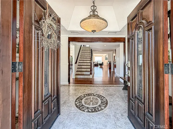 a view of a hallway with wooden floor and front door