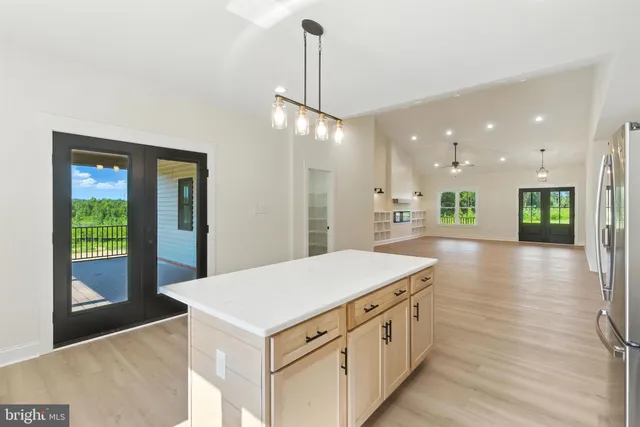 a kitchen with a sink and a wooden floor