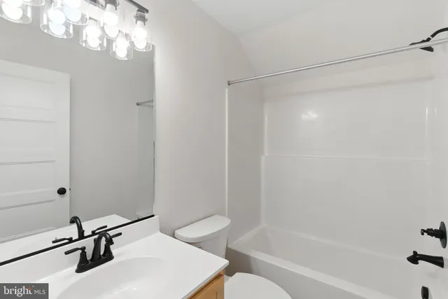 a bathroom with a bathtub a shower a toilet and a sink