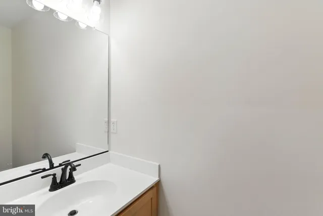 a bathroom with a sink and mirror