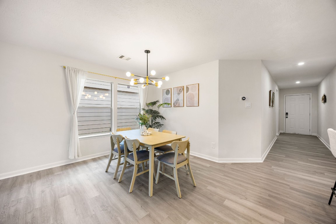 1010 Hummingbird Point Lane Houston, TX 77090 - Photo 11 of 26 Formal dining area perfect for hosting gatherings and everyday meals.