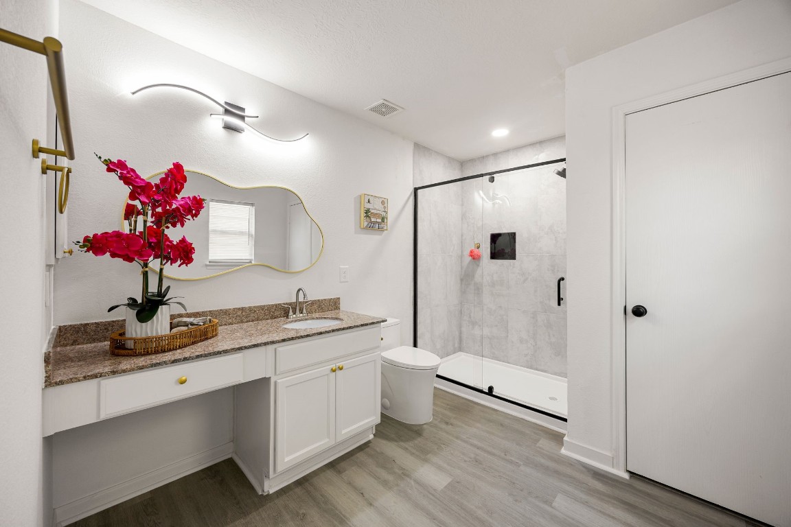 1010 Hummingbird Point Lane Houston, TX 77090 - Photo 14 of 26 Spa-inspired primary bathroom with a walk-in shower and updated finishes.