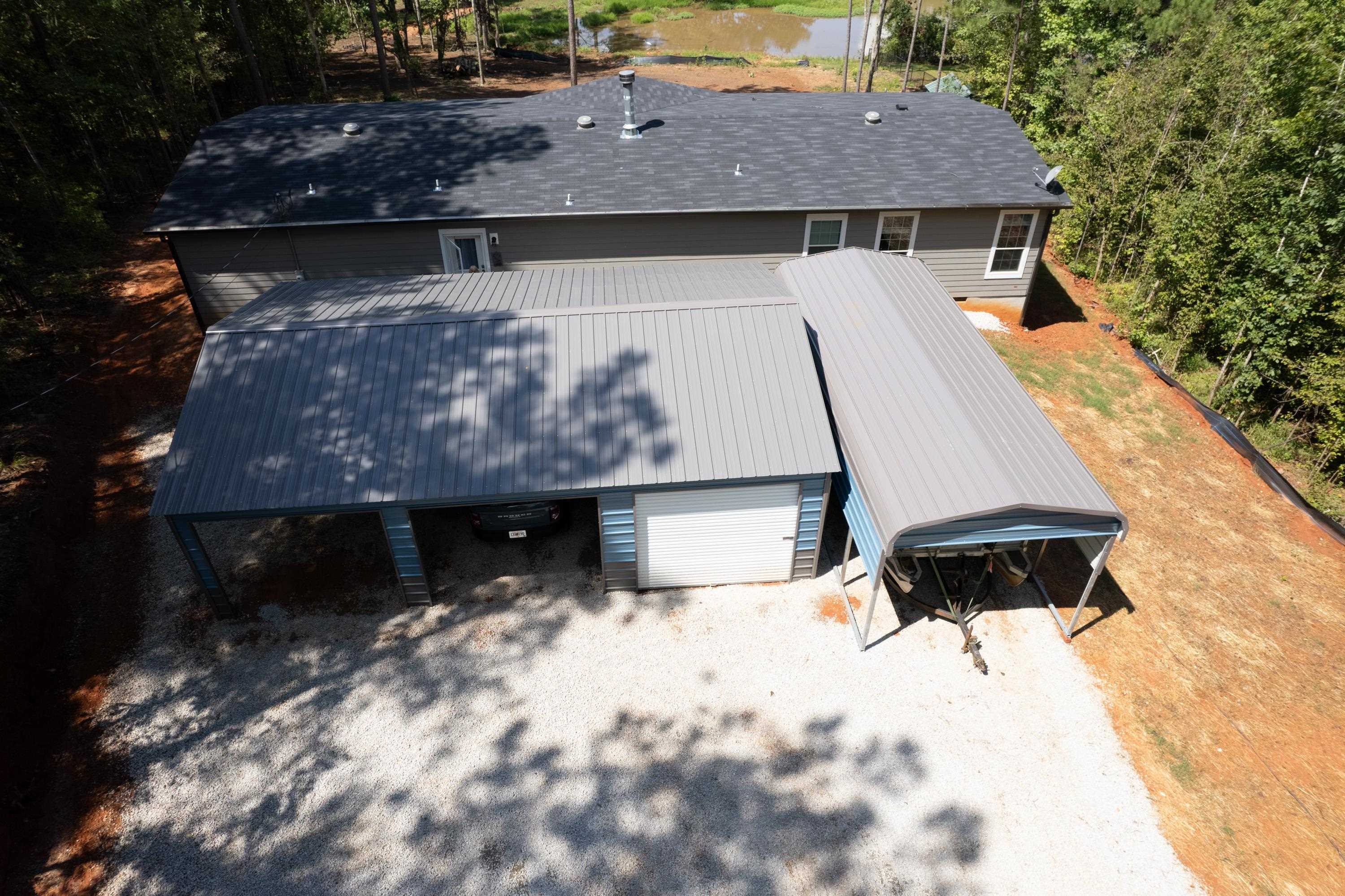 an aerial view of a house with yard and seating space
