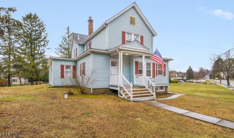 a front view of a house with a yard and balcony