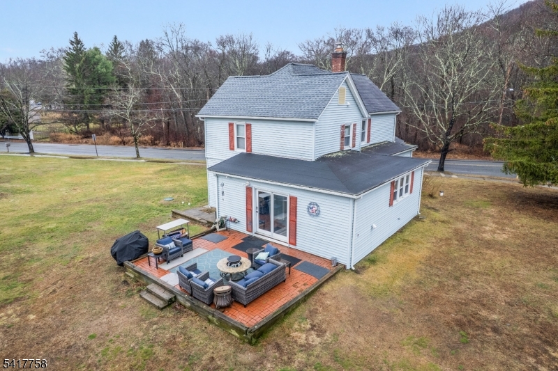 322 Berkshire Valley Road Wharton, NJ 07885 - Photo 24 of 30 a aerial view of a house with swimming pool and trees in the background