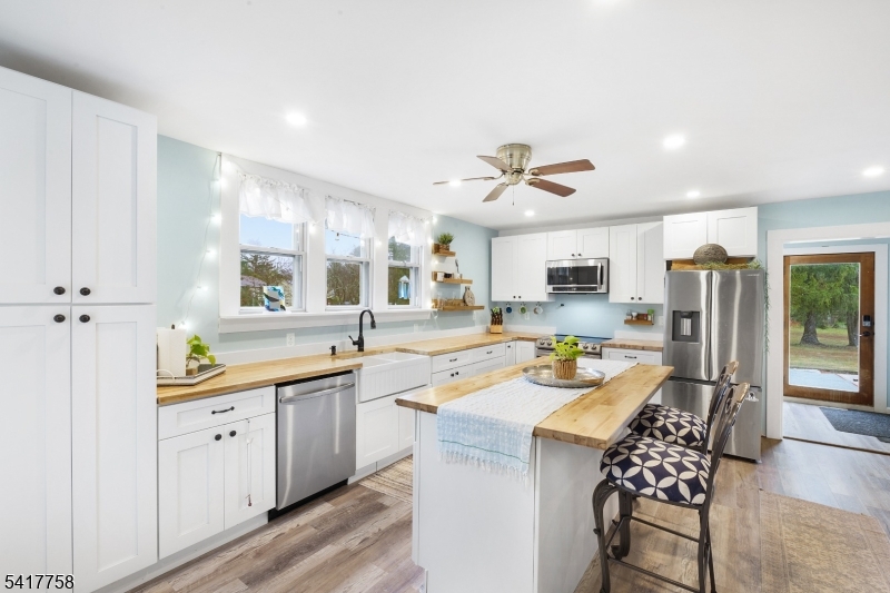 322 Berkshire Valley Road Wharton, NJ 07885 - Photo 6 of 30 a kitchen with stainless steel appliances kitchen island granite countertop a sink and cabinets